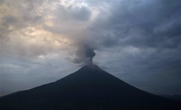 The Tungurahua volcano spews ashes during an eruption as seen Friday from Cotalo, Ecuador.